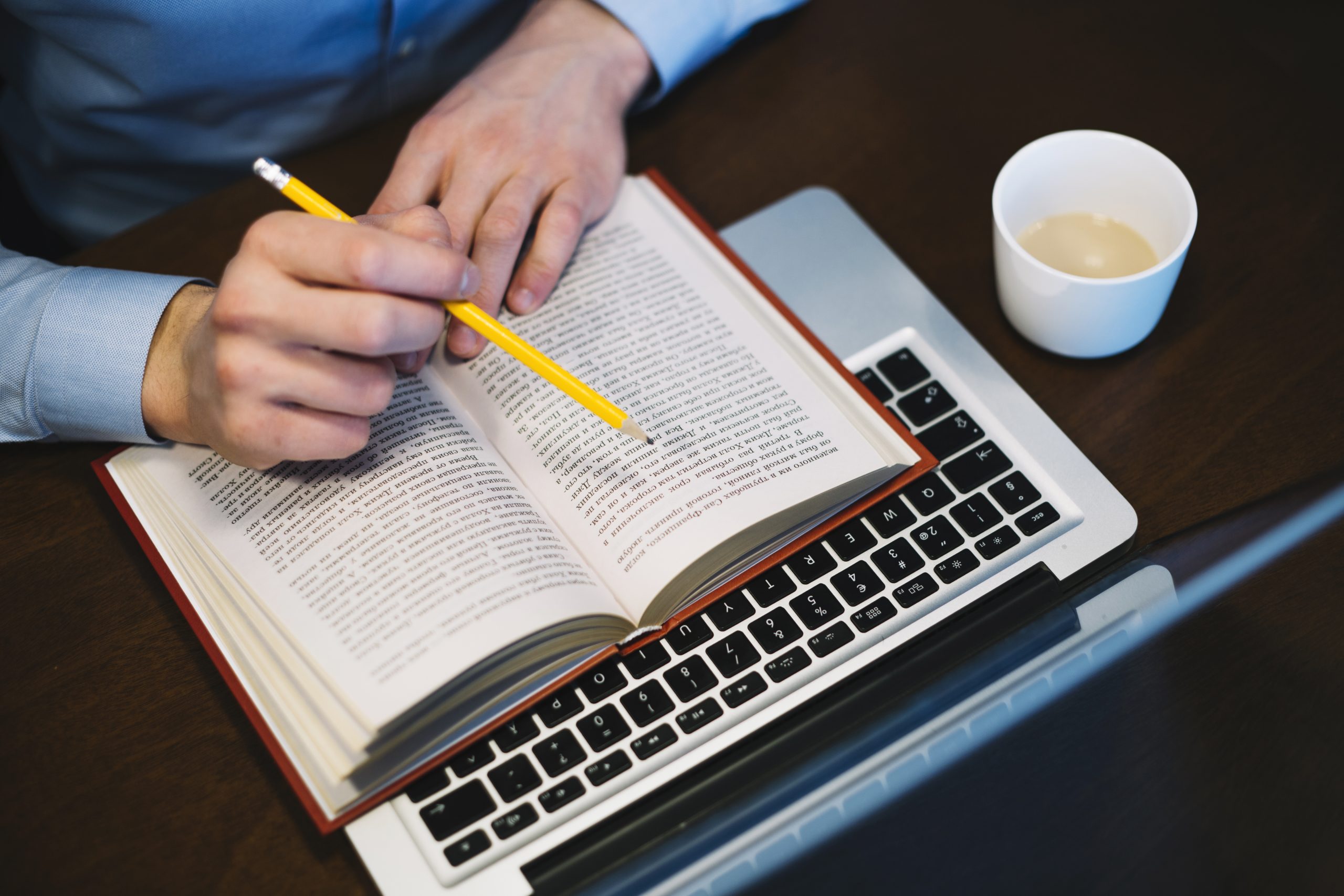crop-man-studying-near-laptop-scaled.jpg